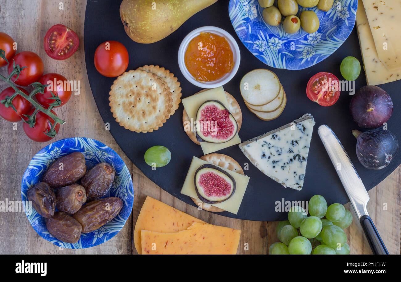 Plateau de fromages aux trois fromages Gouda, avec pimento, gouda avec les graines de cumin et roquefort fromage bleu et fruits assortis close up on rustique en b Banque D'Images