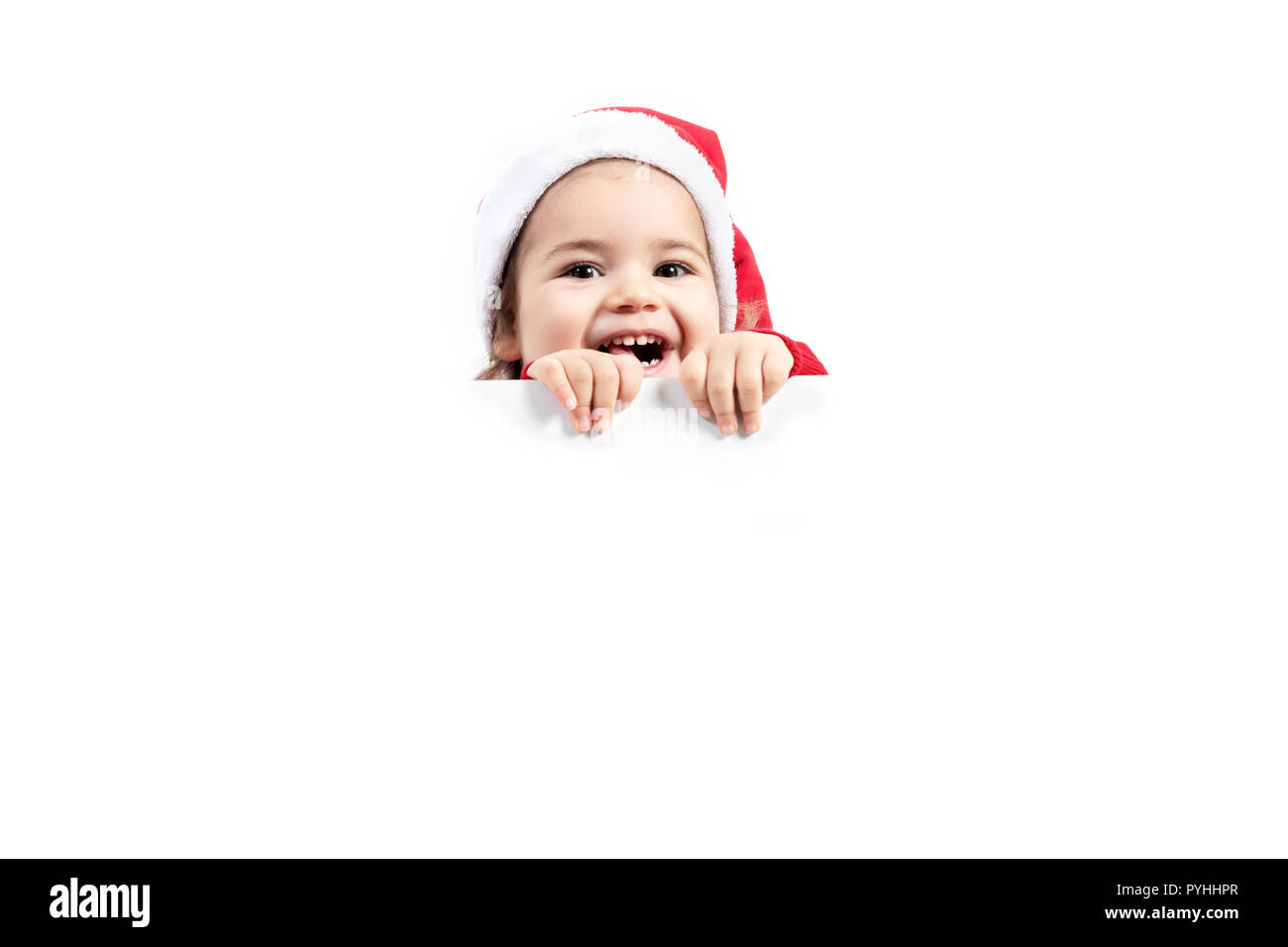 Portrait of happy little girl in Santa hat isolé sur fond blanc. Banque D'Images