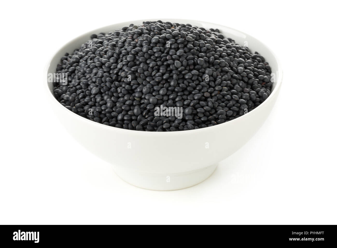 Tas de lentilles beluga bio noir bol en blanc sur fond blanc Banque D'Images