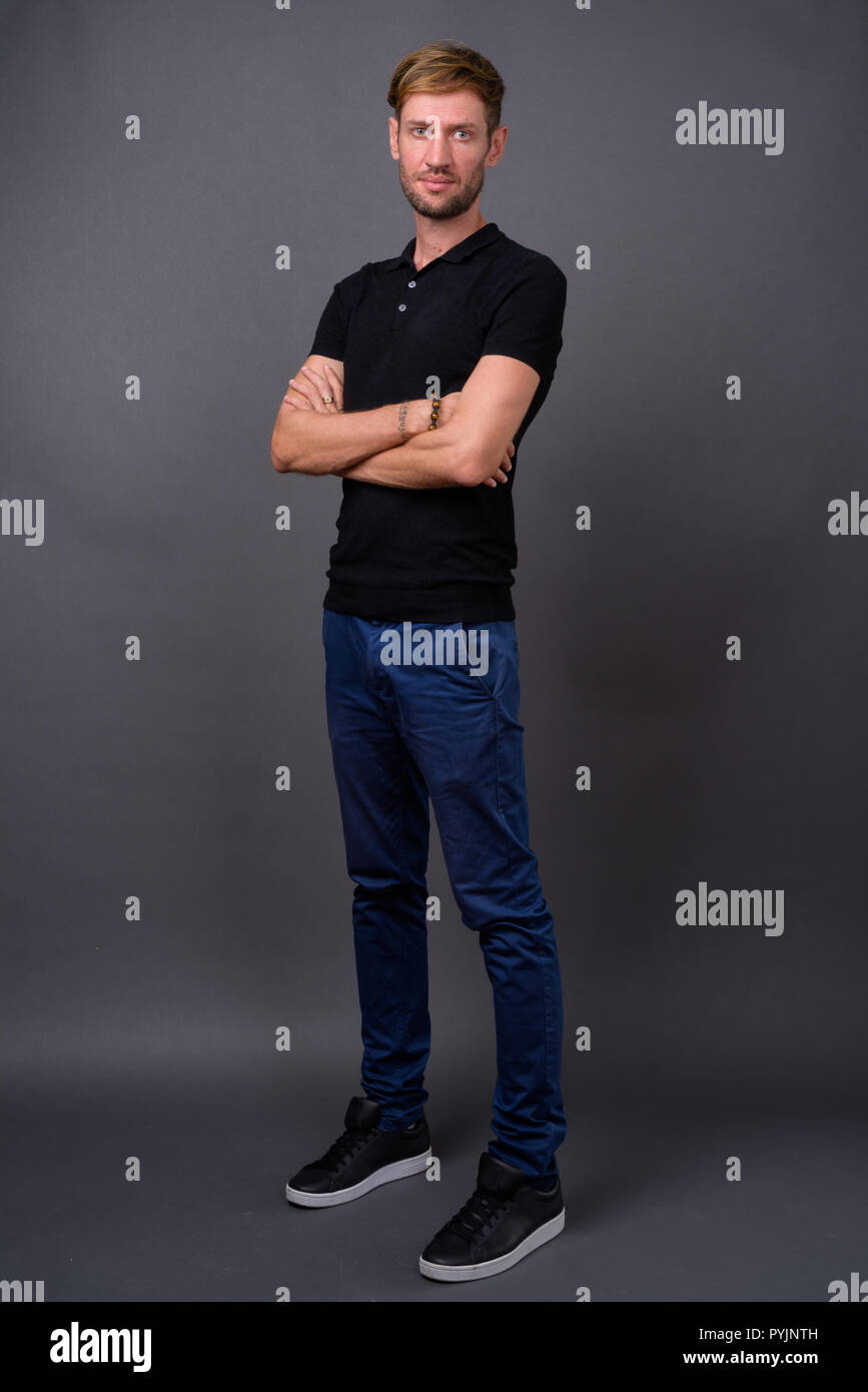 Portrait d'homme barbu blond contre l'arrière-plan gris Banque D'Images