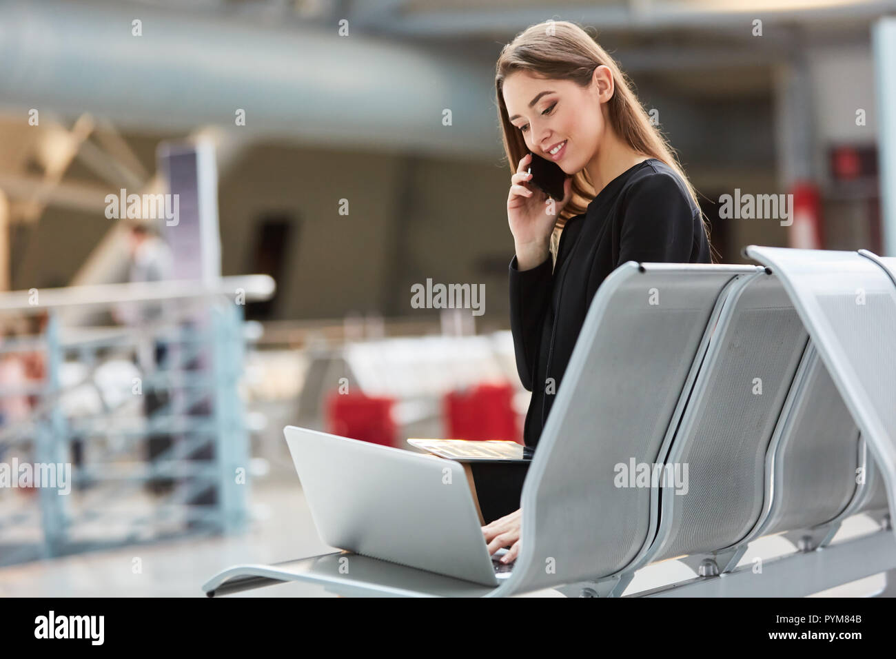 Young business woman using smartphone sur un voyage d'affaires à airport terminal Banque D'Images