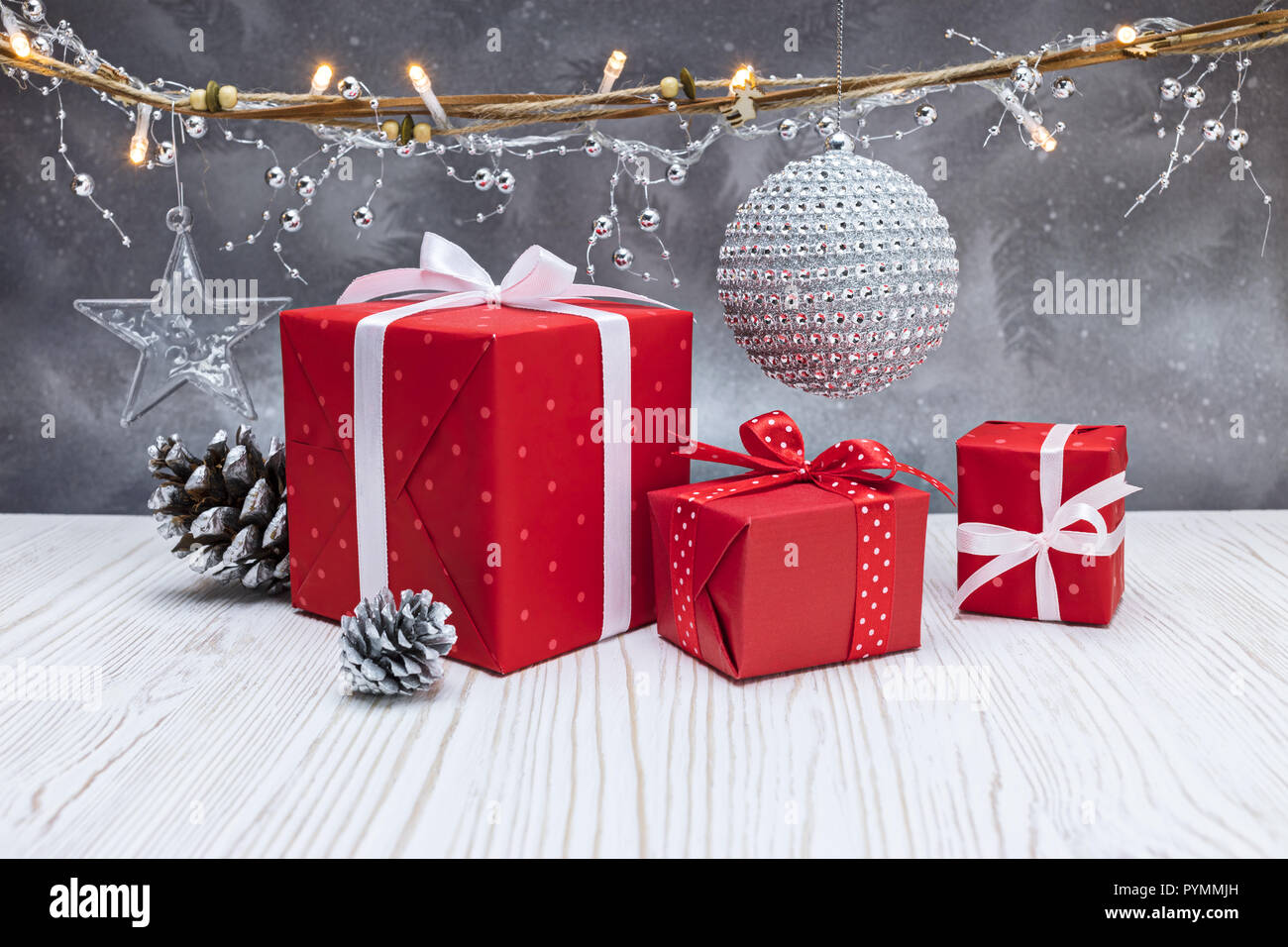 Décorations de Noël, cadeaux, déco rouge silver ball et la foudre garland gris sur fond d'hiver givré Banque D'Images