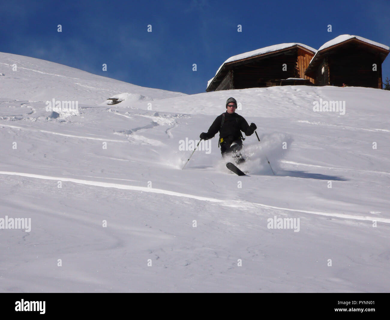 Homme telemark à l'arrière-pays Suisse profonde en hiver et poudreuse fraîche sur une belle journée Banque D'Images