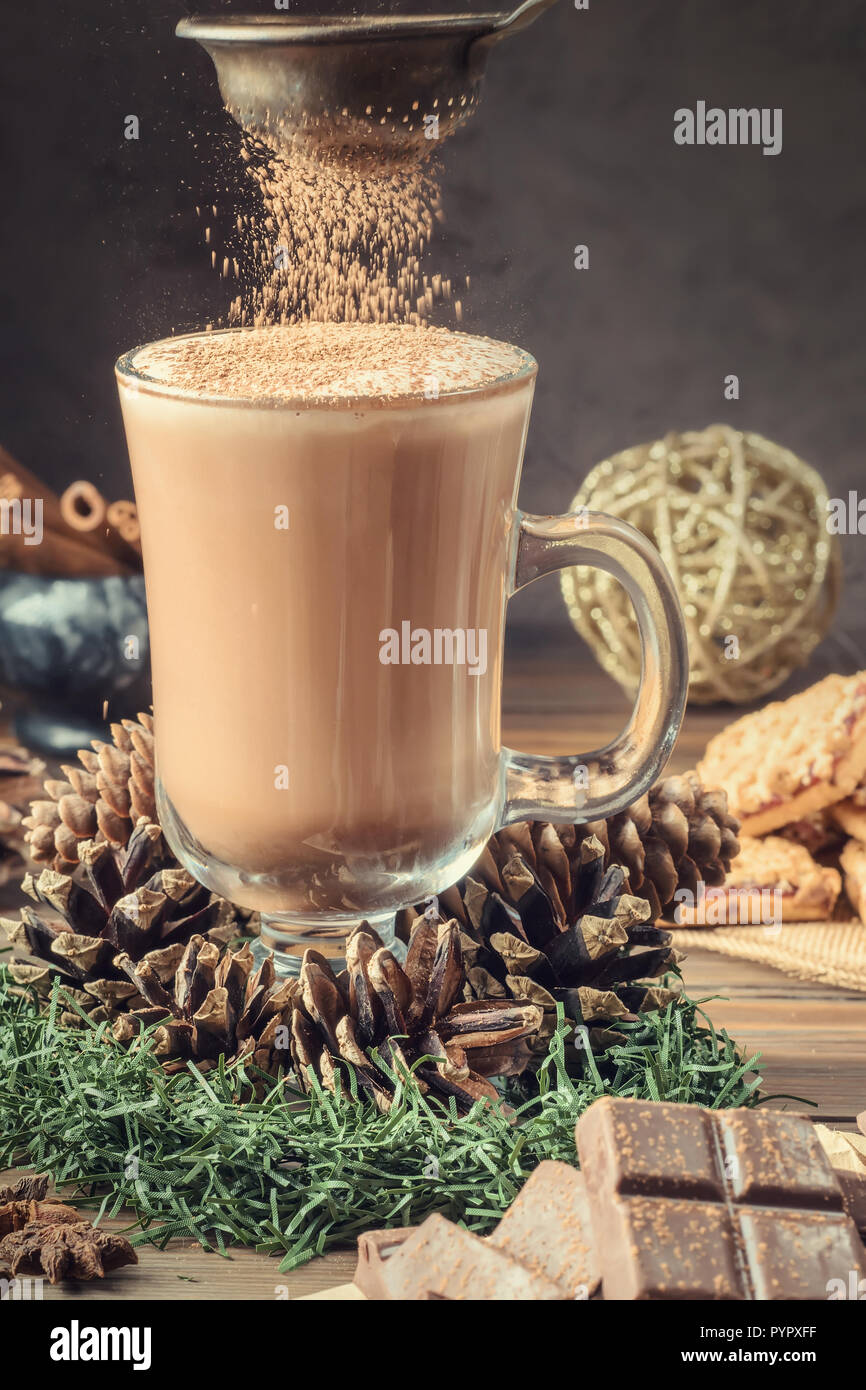 Tasse de café ou de cacao de verre avec mousse de lait sur la table en bois chocolat cannelle cookies servis des vacances d'hiver et accessoires. Carte de Noël Nouvel An. H Banque D'Images