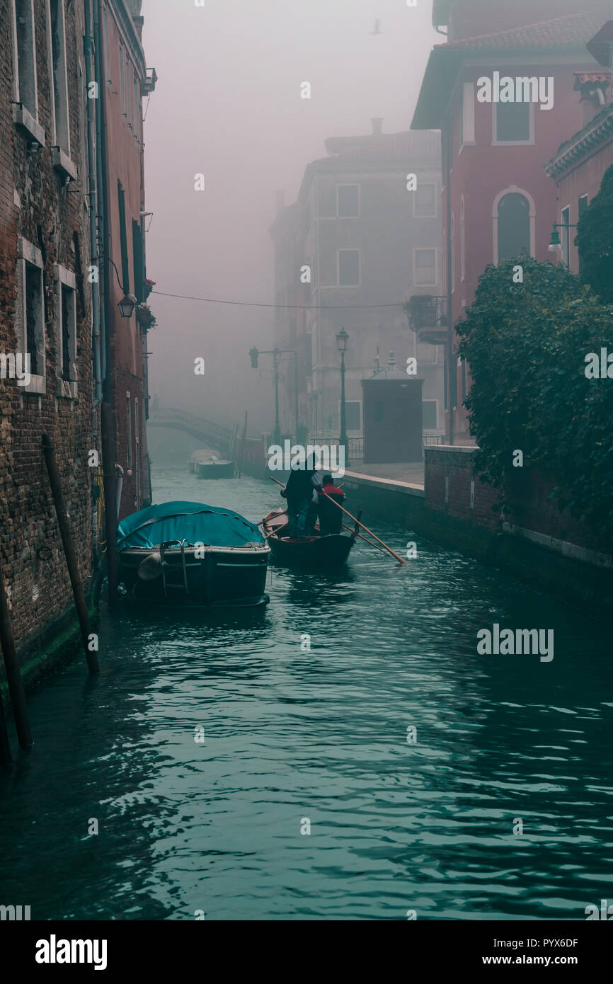 Croisière en gondole sur les canaux de Venise Italie sur un matin brumeux (personnes au travail) Banque D'Images