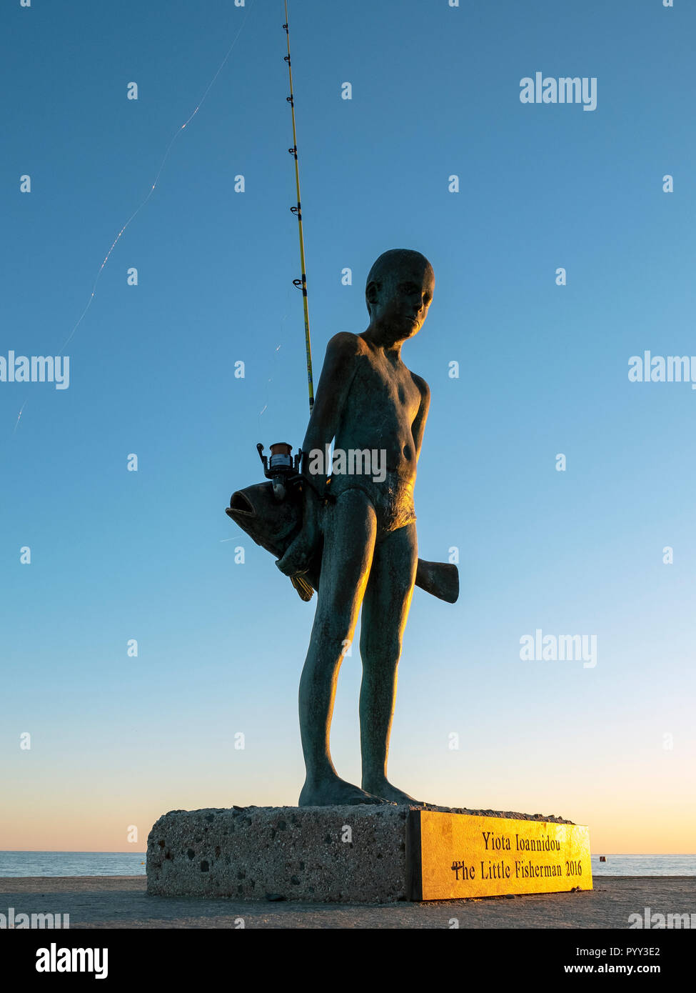 Le petit pêcheur"- une sculpture en bronze d'un jeune garçon et un gros poisson, par l'artiste Anna Maria Ioannidou, Paphos. Banque D'Images