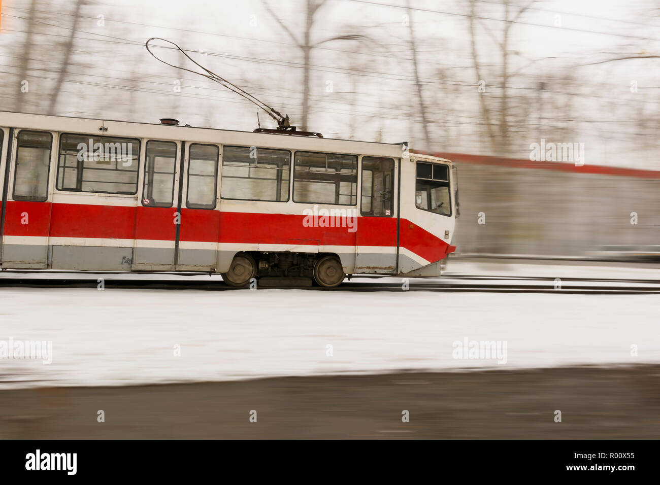 En tram coloré de flou. Tramway orange colorée, se déplaçant à grande vitesse - arrière-plan flou. Banque D'Images