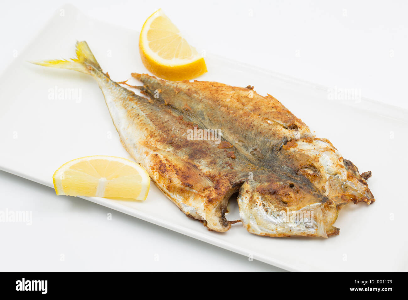 Un Scad faits maison, ou Chinchard Trachurus trachurus, qui, a été divisée, trempé dans de la farine assaisonnée avec le cumin et le paprika et frits sur les sid Banque D'Images