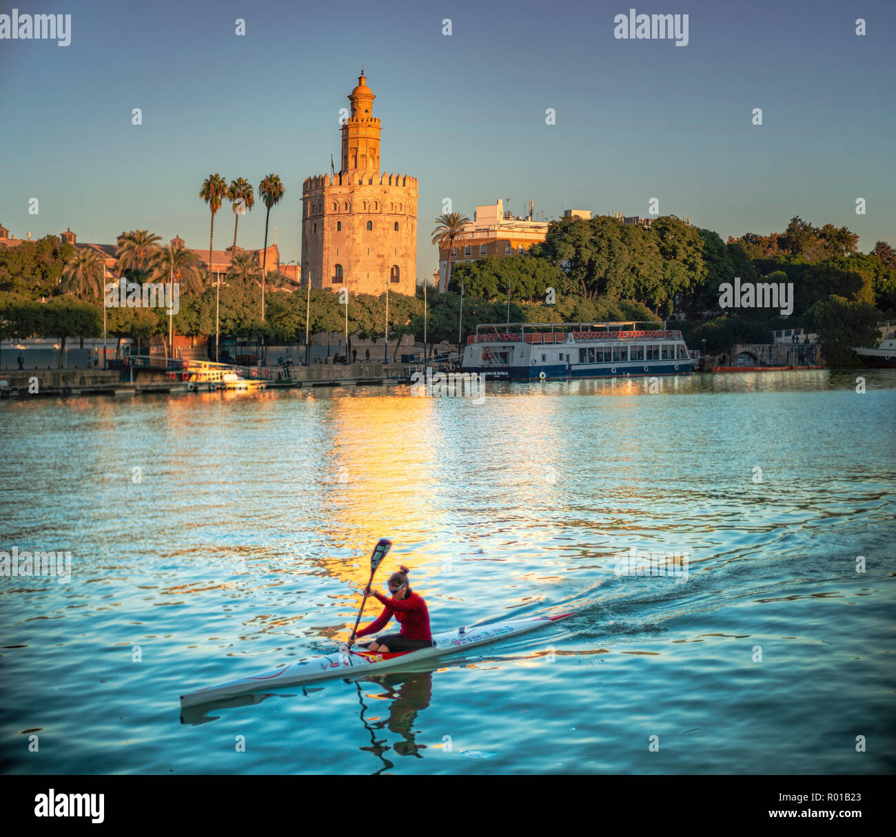 Canoéiste sur le Guadalquivir, en face de la tour d'Or (12ème siècle monument), Séville, Espagne. Banque D'Images