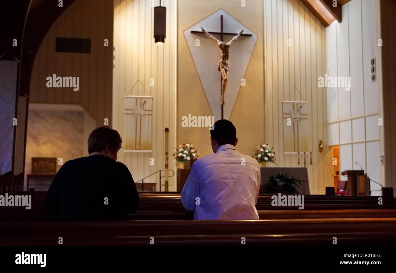 Middletown, CT USA. Apr 2016. Un jeune homme et femme en prière dans l'église avec un moment de parler. Banque D'Images