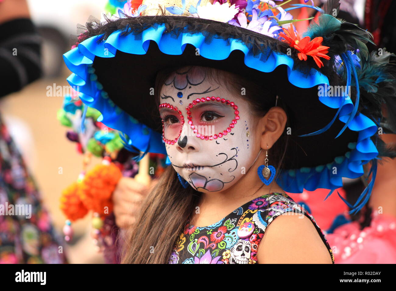 Jeune fille avec le joli crâne en sucre (Catrina) un miroir à jour des Morts (Dia de los Muertos) célébration Banque D'Images