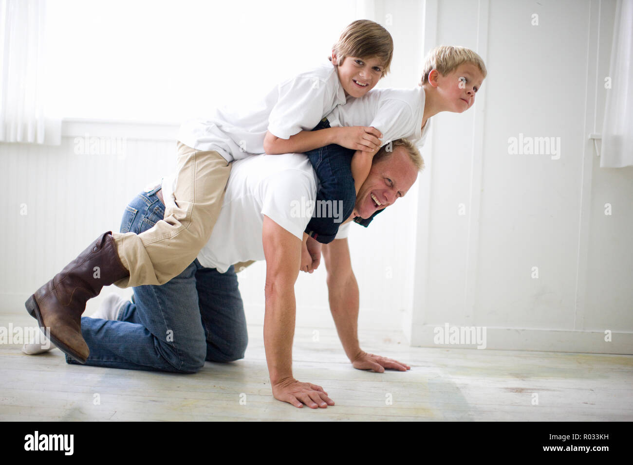 Père s'amuser tout en jouant avec ses deux jeunes fils. Banque D'Images
