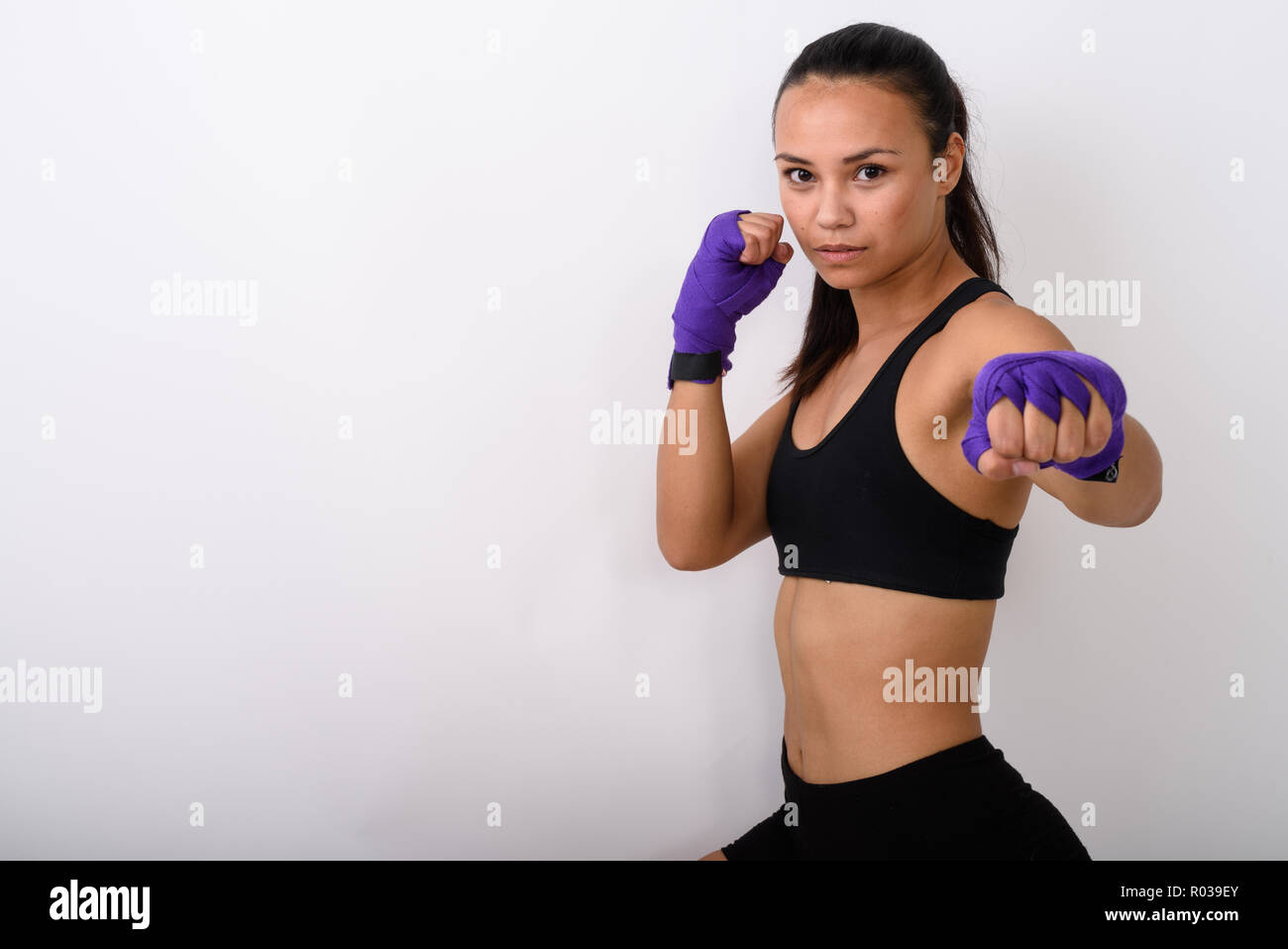 Studio shot of young Asian woman fighter avec enveloppements boxe prêt Banque D'Images