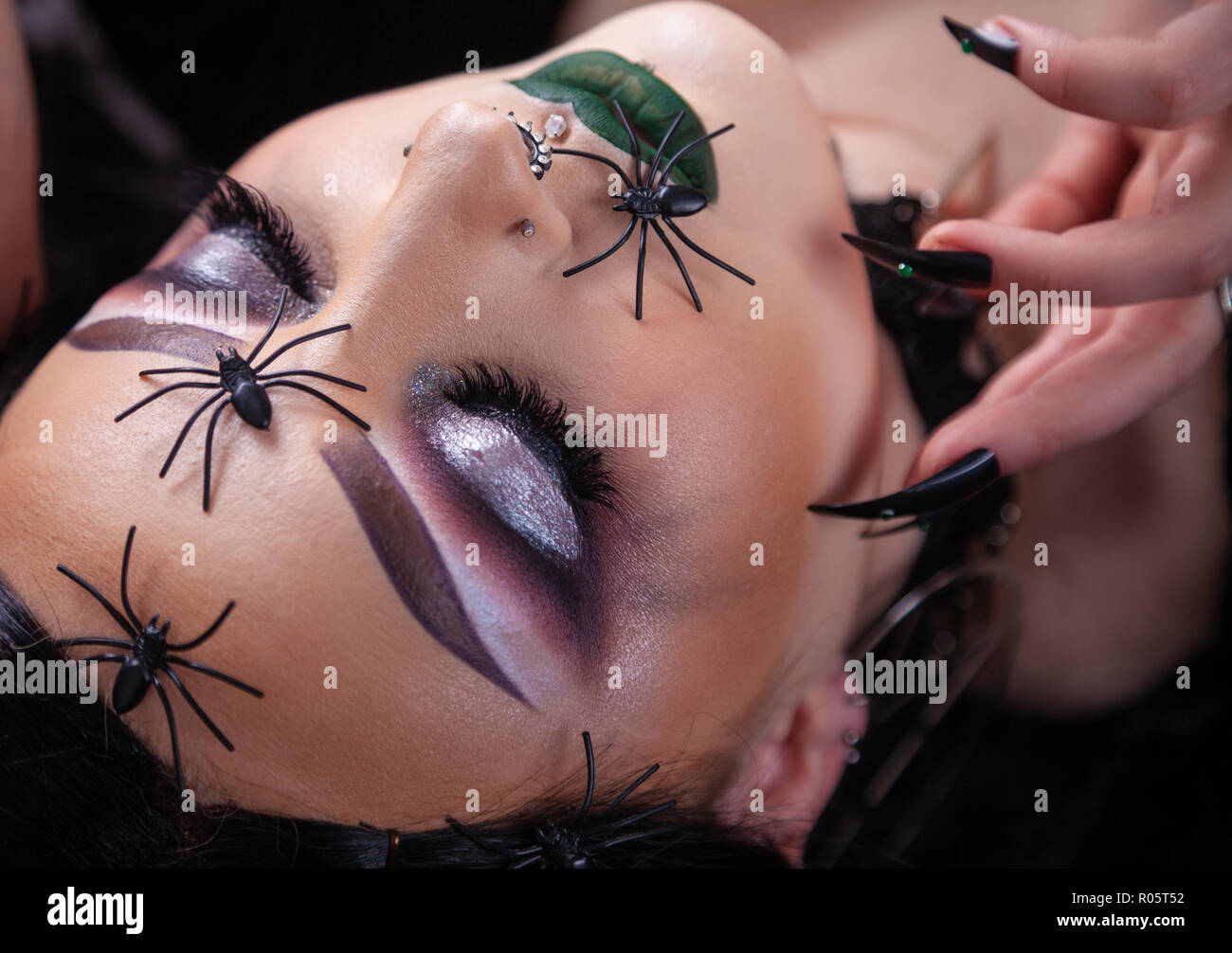 Close up of a woman's face à la gothique avec de fausses araignées en plastique. Banque D'Images