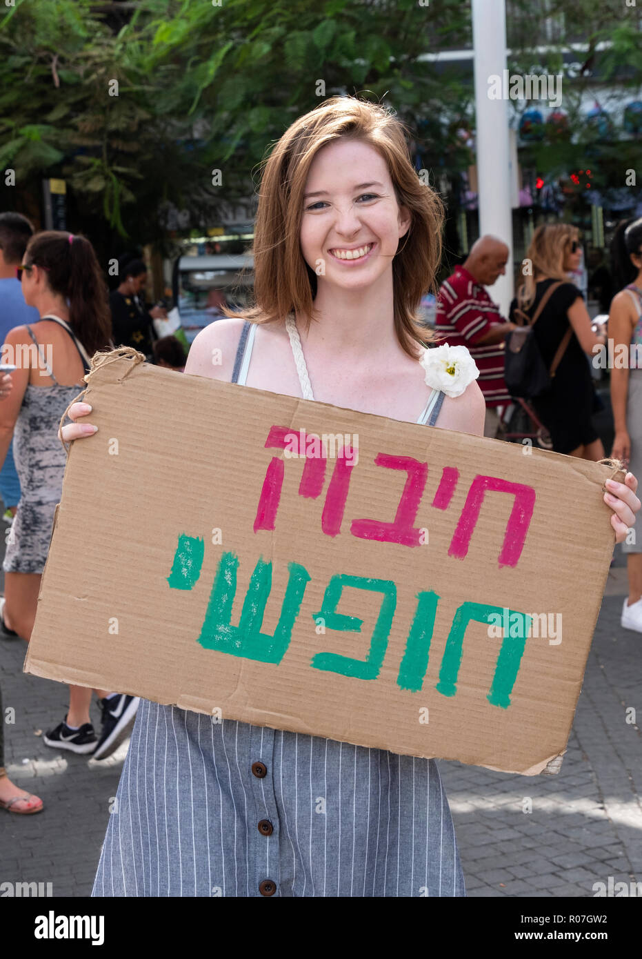 Une jeune dame avec un panneau disant hébreu 'Free Hug" au marché de Carmel à Tel Aviv, Israël. Banque D'Images