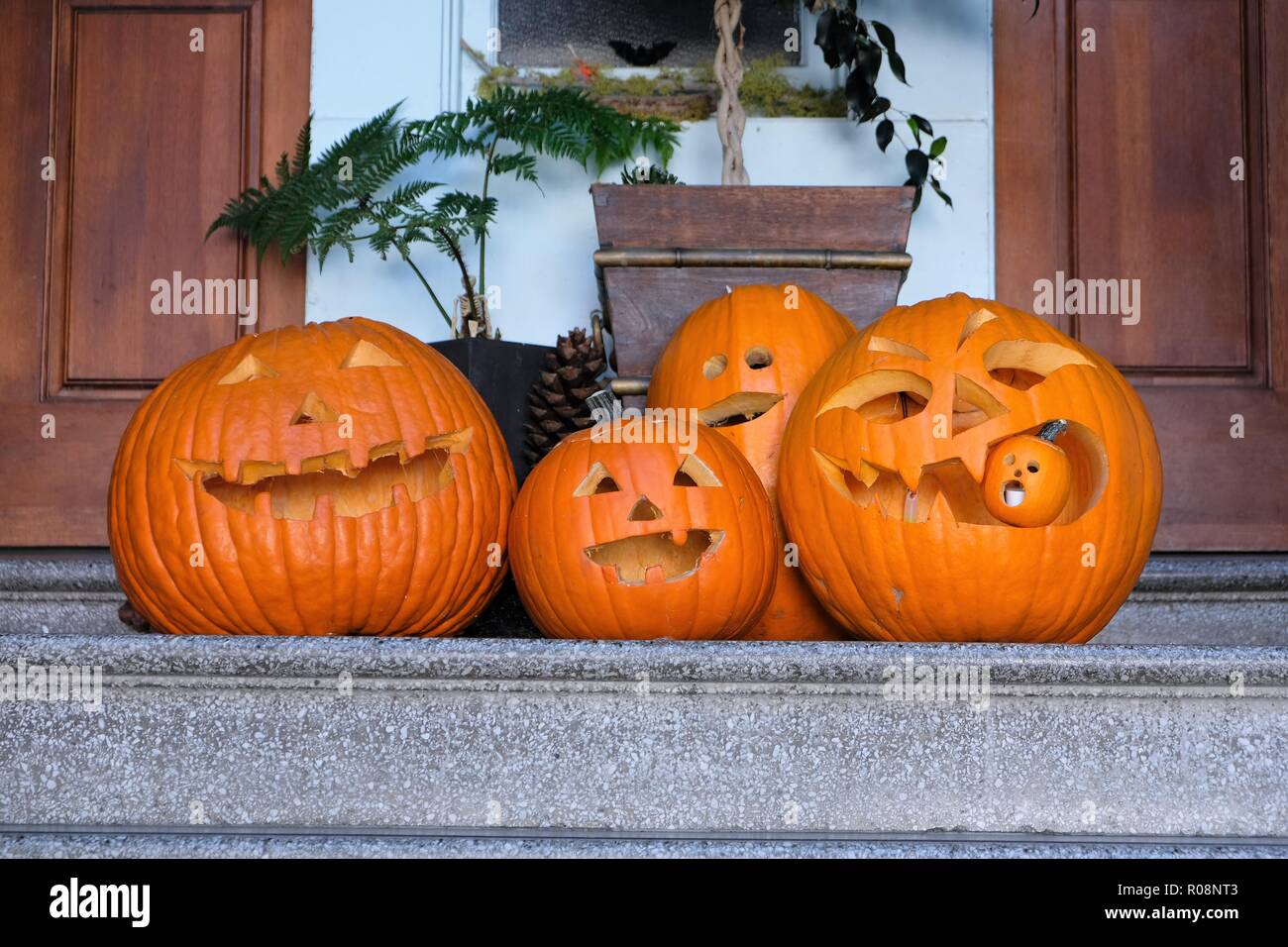 De la famille des citrouilles Halloween sculpté sur une porte. Banque D'Images