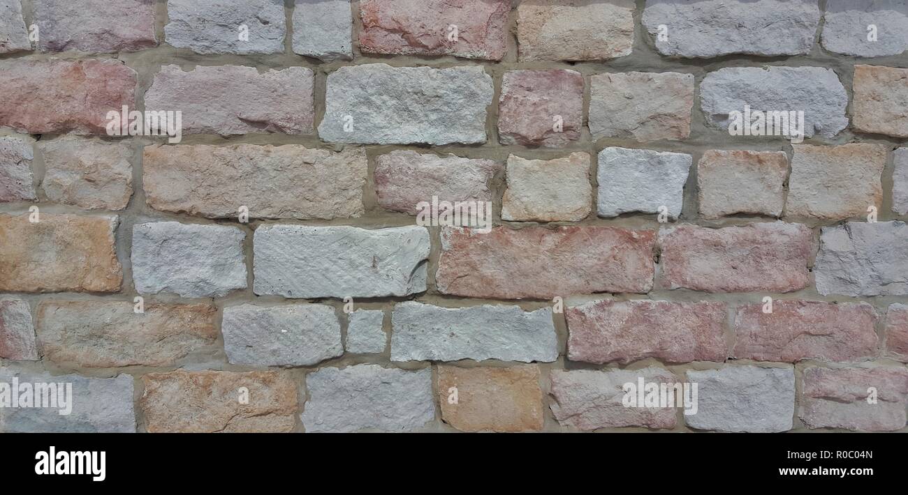 Textures rugueuses d'un mur de briques colorées. Banque D'Images
