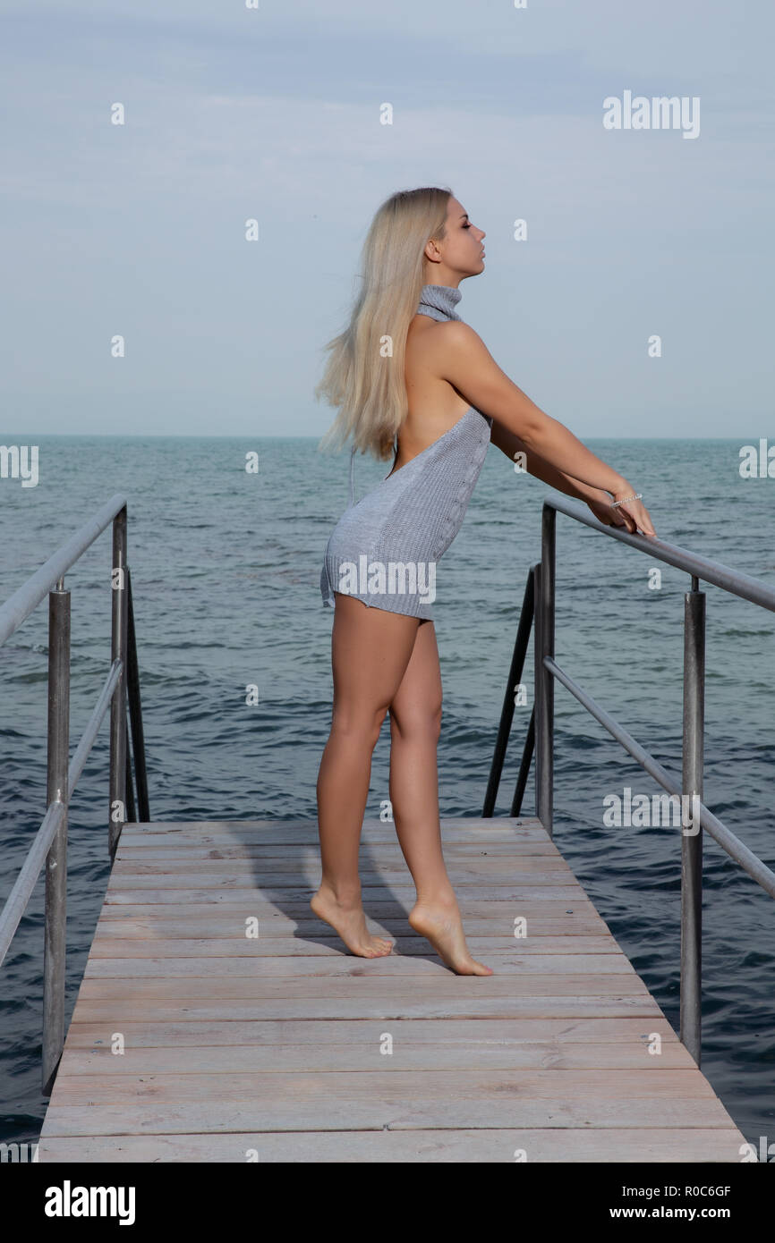 Woman posing sur la jetée de robe courte Banque D'Images