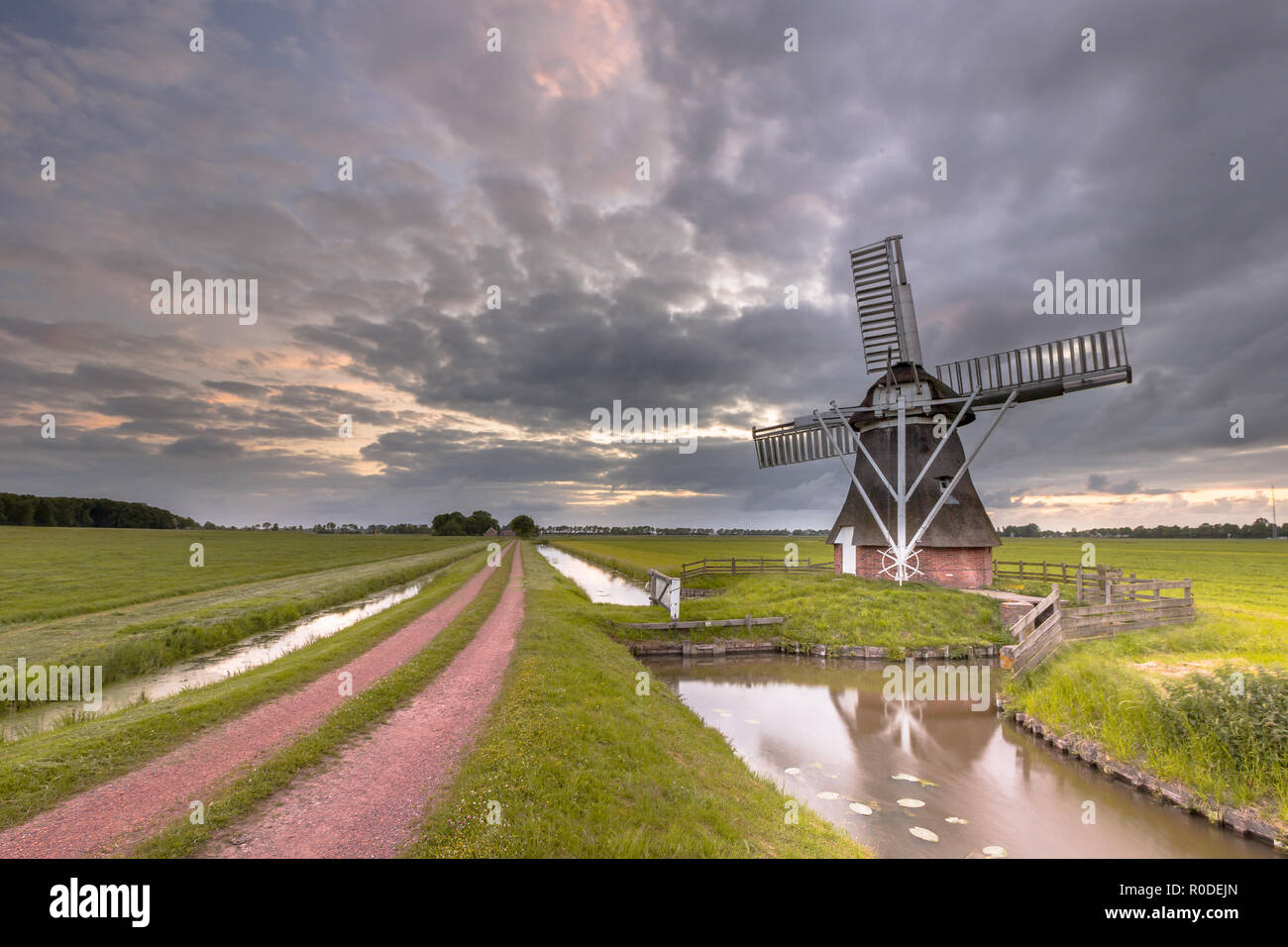 Ancien moulin à vent en bois le long d'un chemin rural dans paysage de polders aux Pays-Bas. Dans le passé, ces bâtiments utilisés pour jouer un rôle dans la gestion de l'eau Banque D'Images