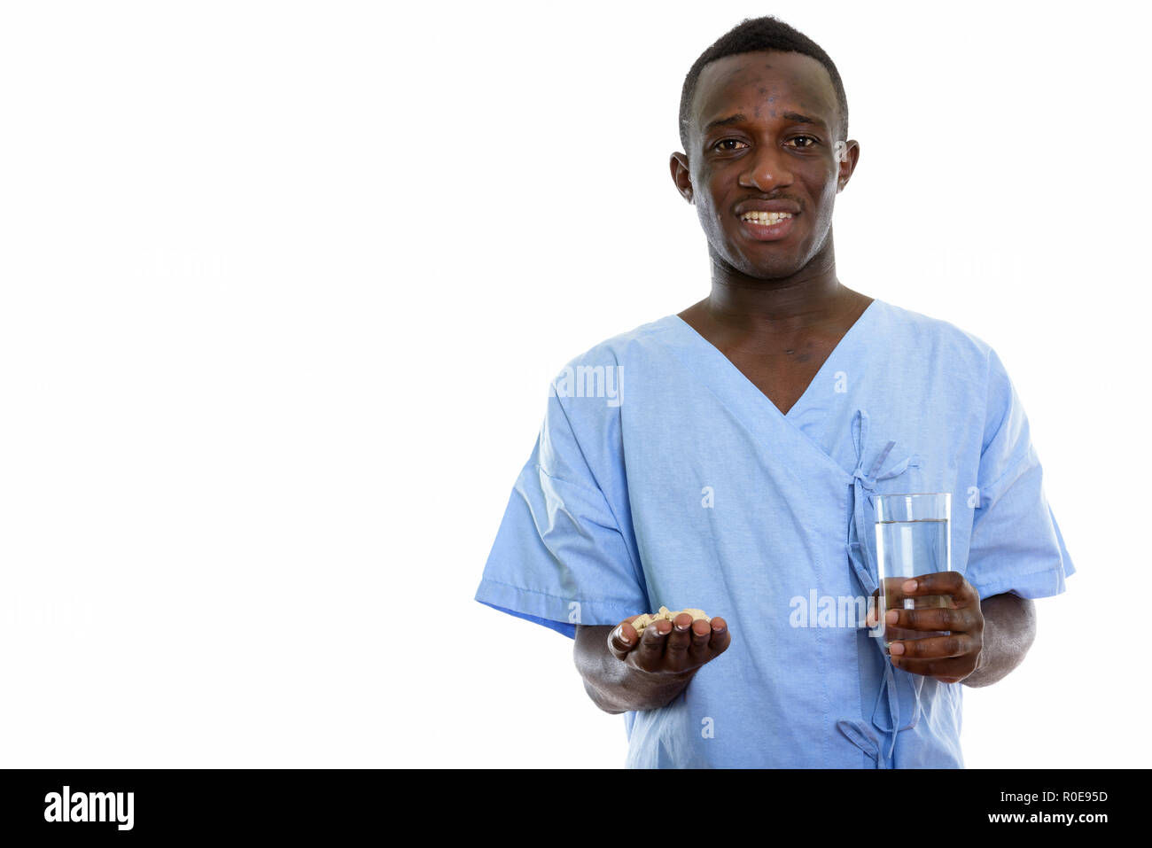 Studio shot of young happy black African man smiling patient whi Banque D'Images