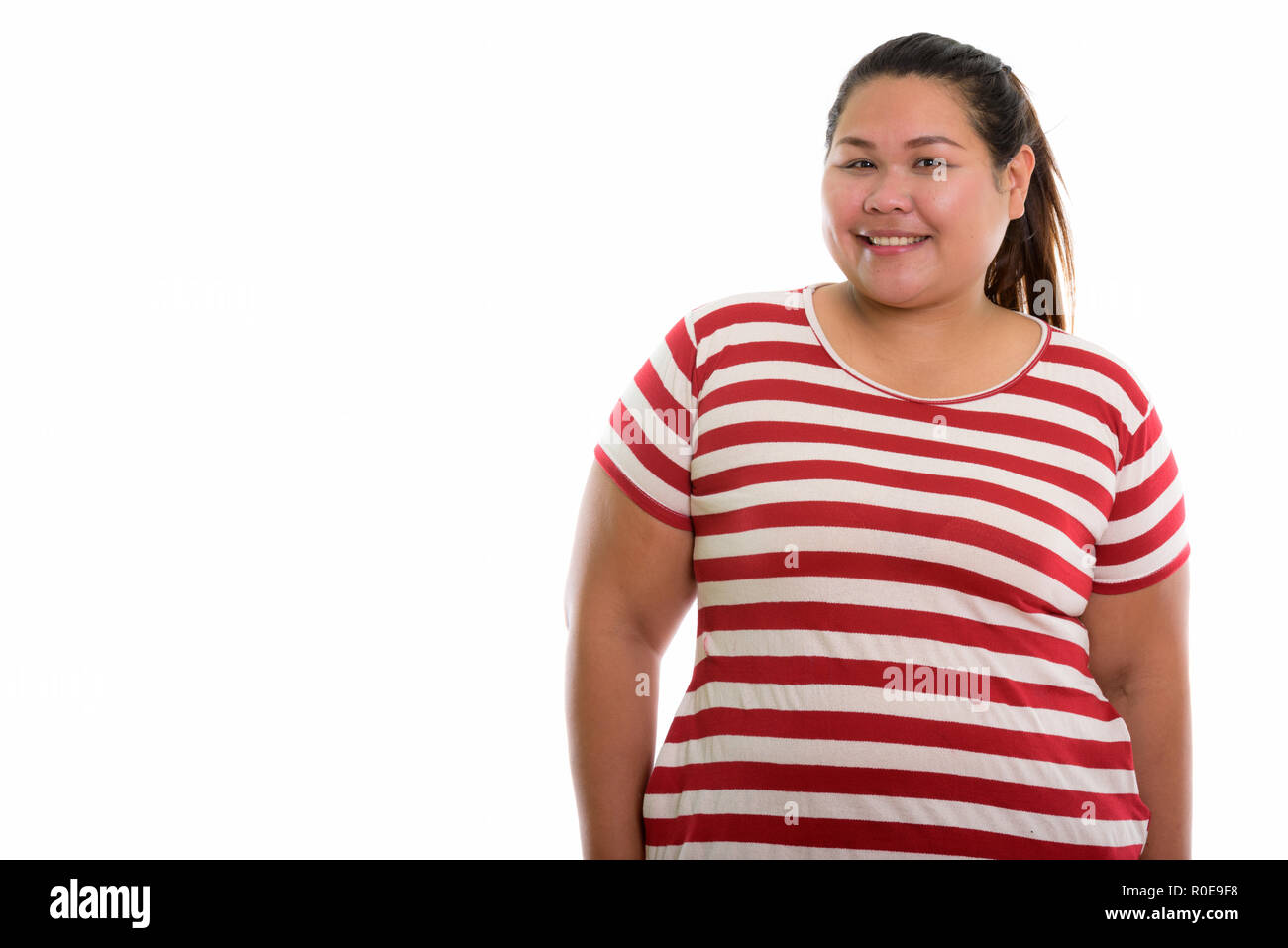 Studio shot of young woman smiling happy fat Banque D'Images