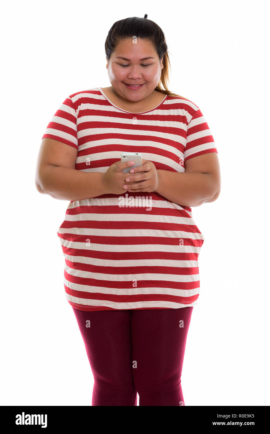 Studio shot of young happy fat woman kissing Banque D'Images