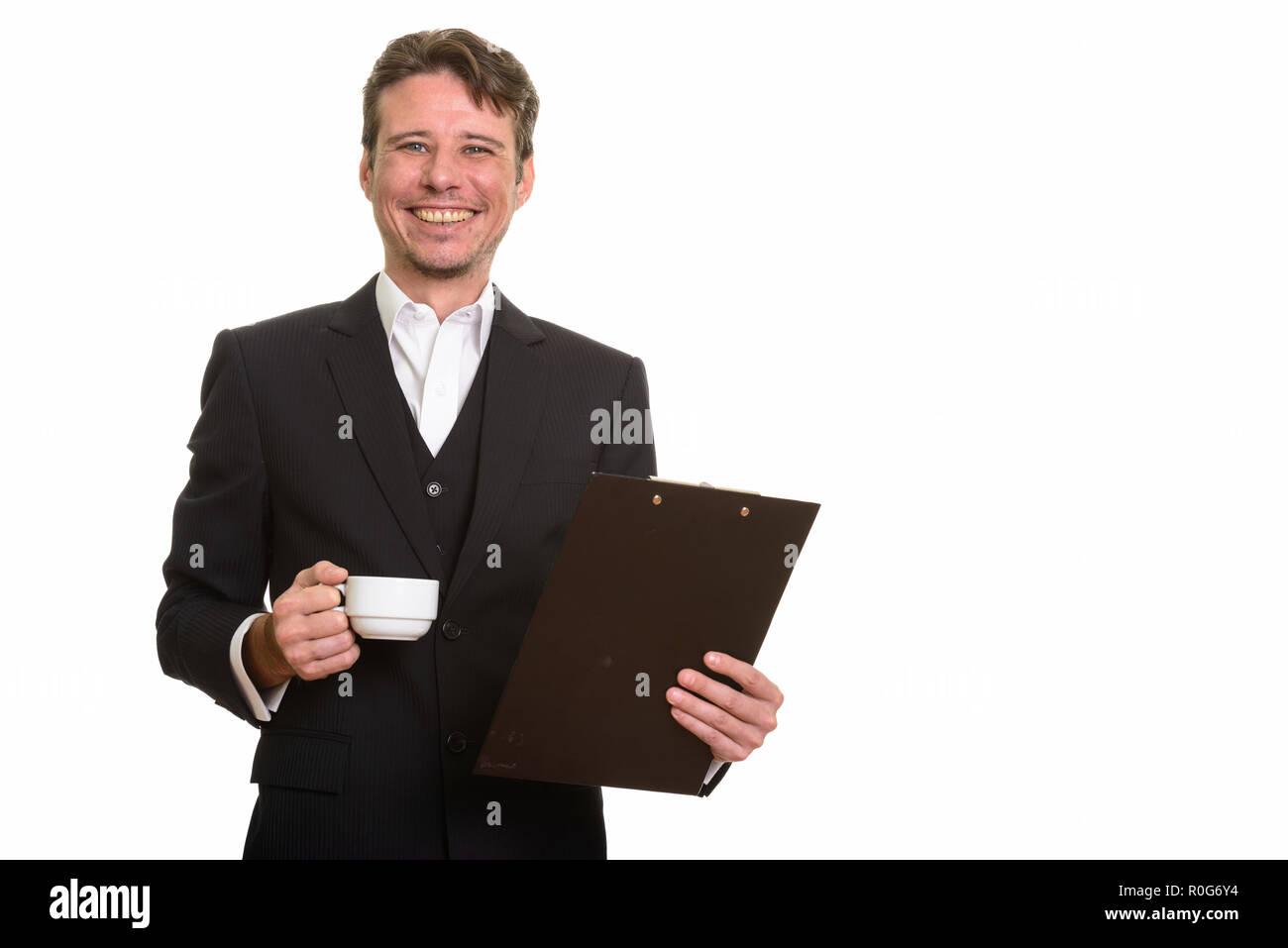 Happy Caucasian businessman holding clipboard and Coffee cup Banque D'Images