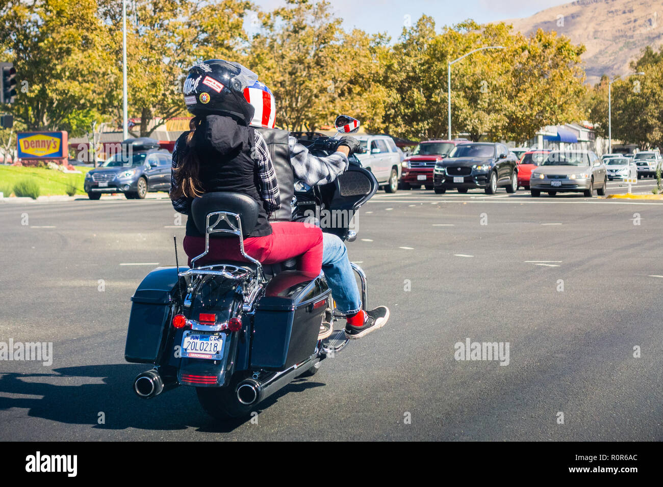 6 octobre 2018 Milpitas / CA / USA - Couple riding sur une moto portant des casques avec le drapeau américain et la carte Banque D'Images