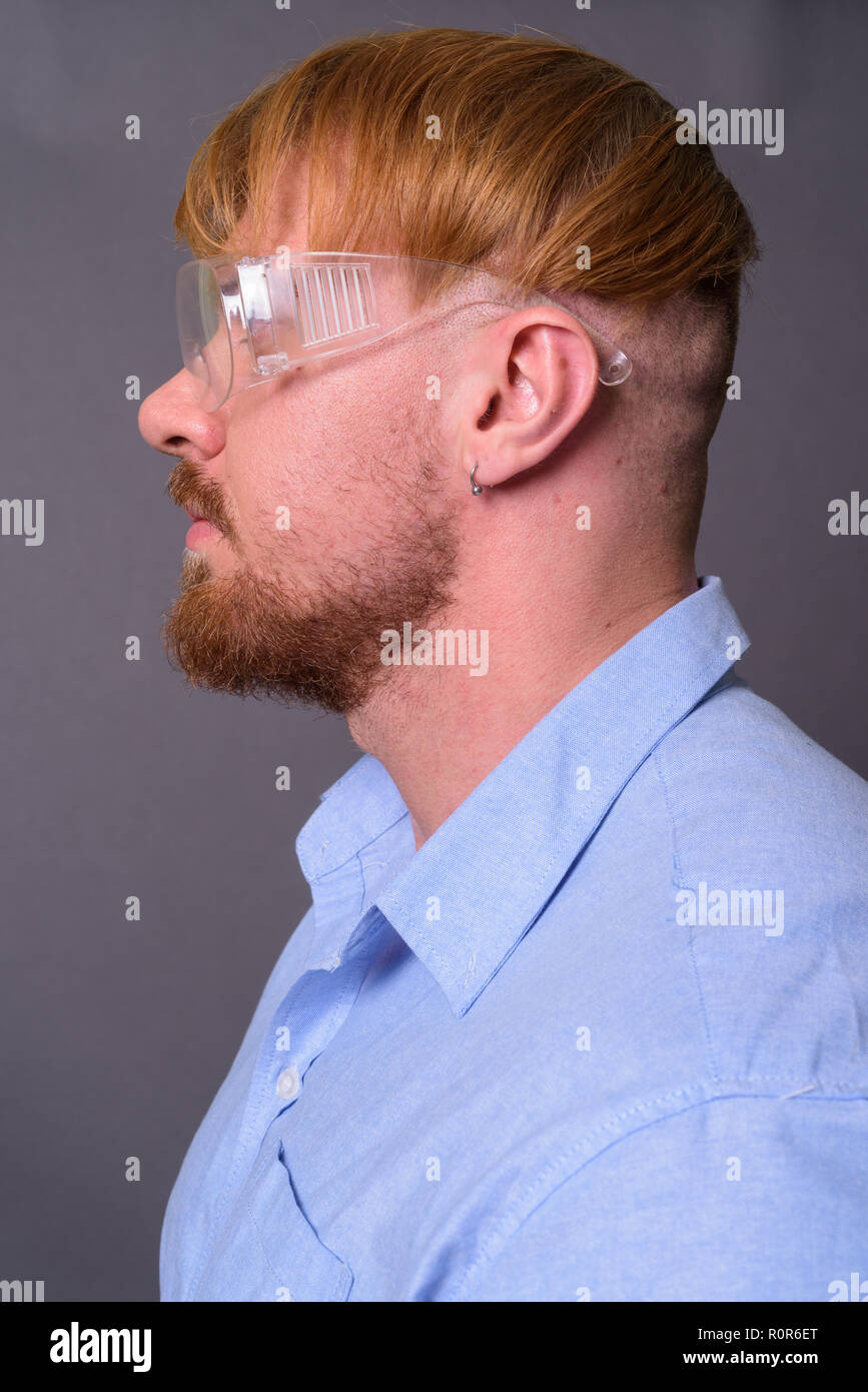 Médecin homme barbu avec des cheveux blonds portant des lunettes de protection ag Banque D'Images