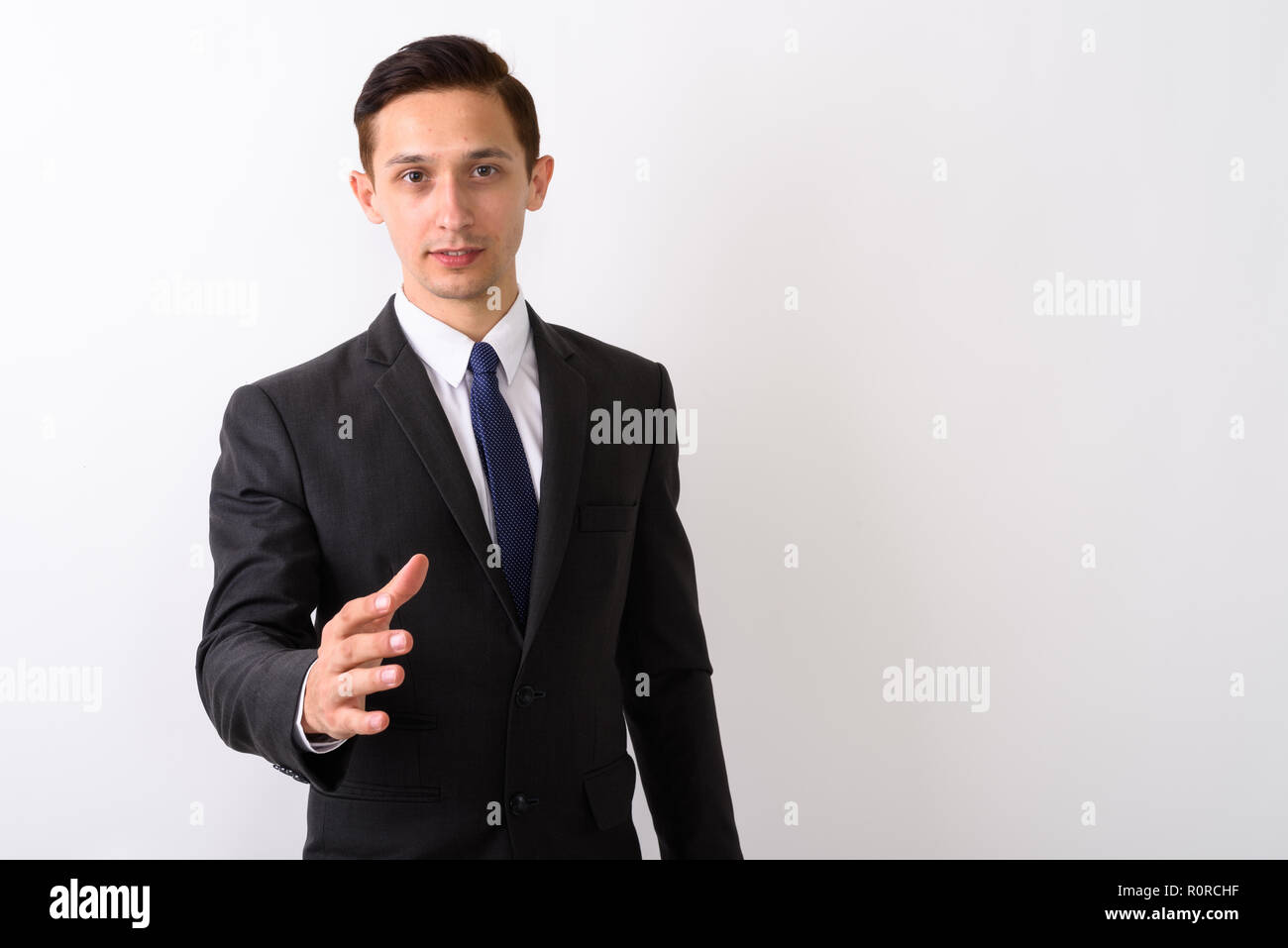 Studio shot of young handsome businessman nouveau handshake Banque D'Images