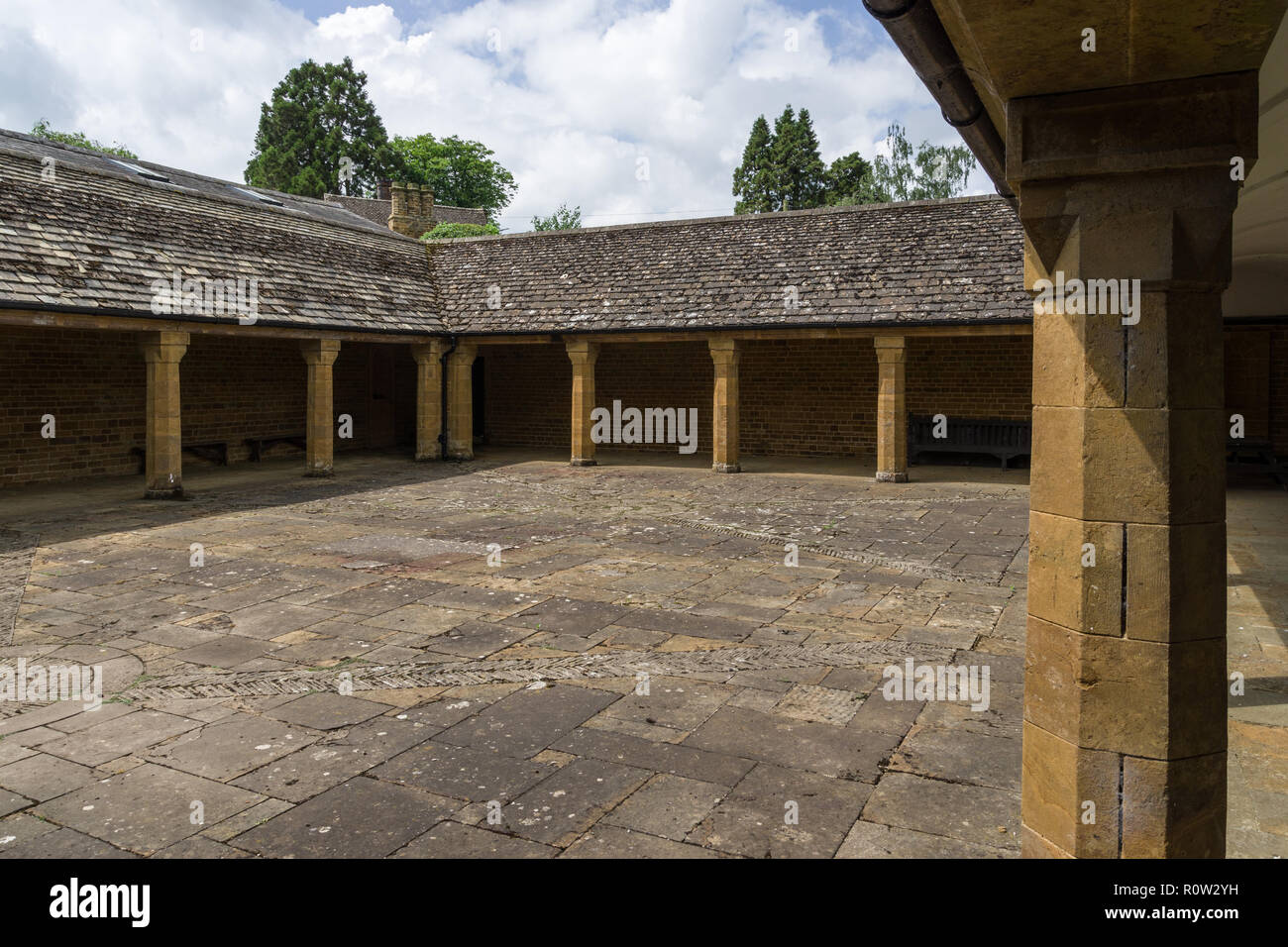 La joie de l'Hydromel Jardins, Farthingstone, Northamptonshire, Angleterre ; un jardin caché avec cloître de pierre, un petit temple et de la pelouse pour le bien du village. Banque D'Images