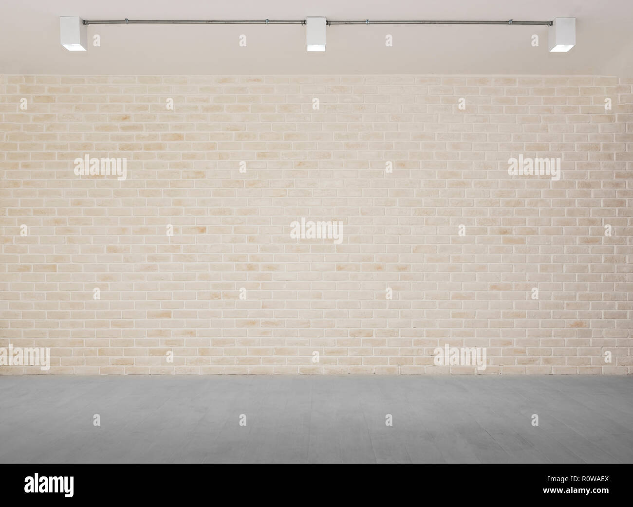 Résumé fond de mur de briques avec sol en béton gris avec la lumière des lampes. Vintage studio. Photo pour ajouter du texte message. Contexte pour la conception Banque D'Images