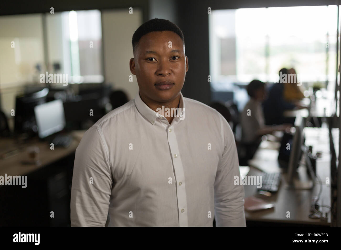 Male executive looking at camera in office Banque D'Images