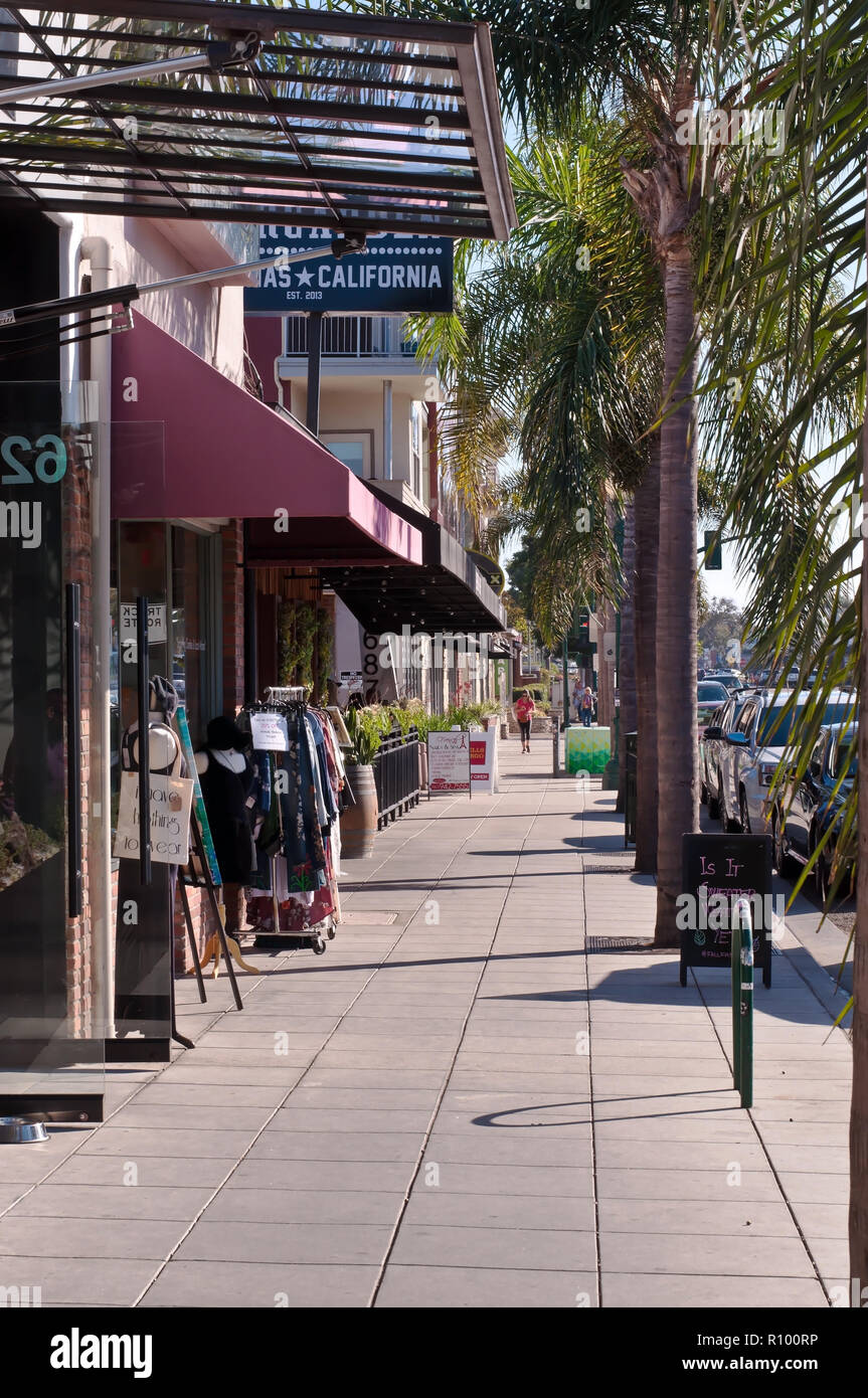 Un trottoir bordé d'arbres le long d'un commerce à Encinitas, Californie, USA Banque D'Images