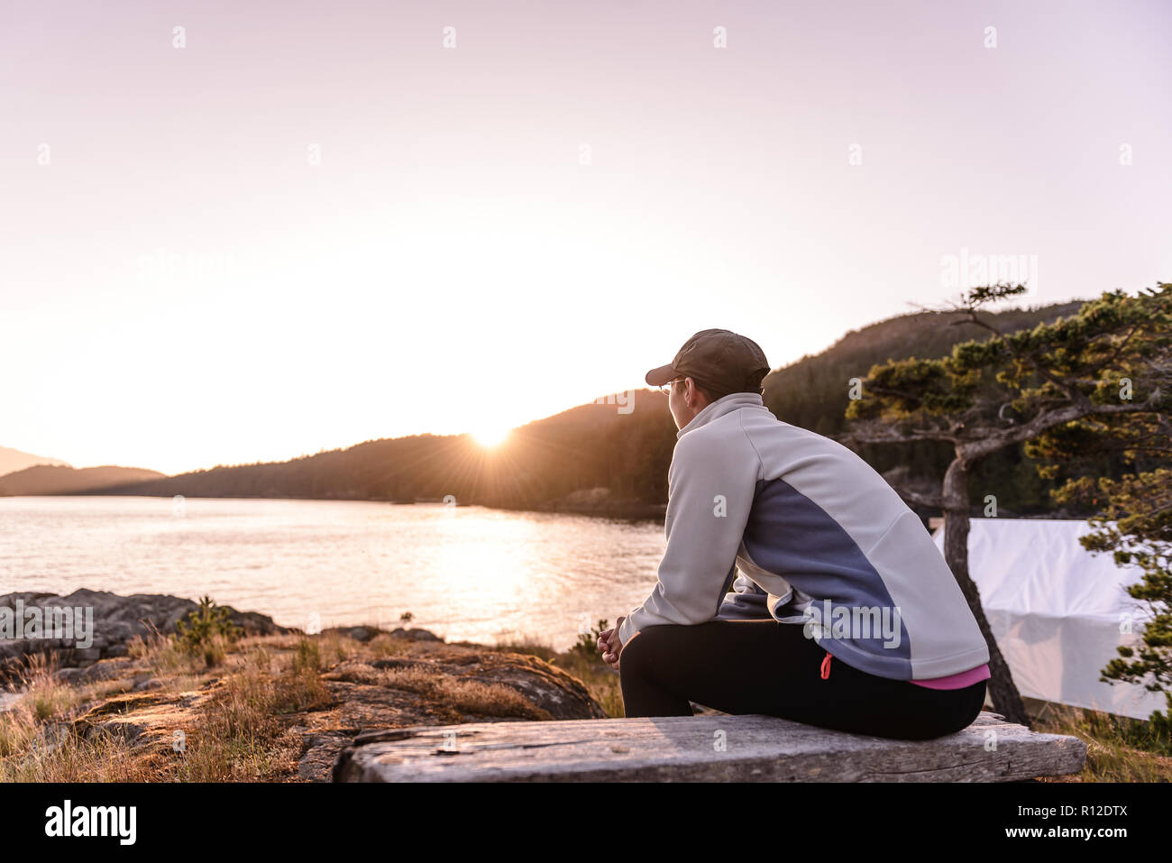 Woman relaxing by Lakeside, le détroit de Johnstone, Telegraph Cove, Canada Banque D'Images