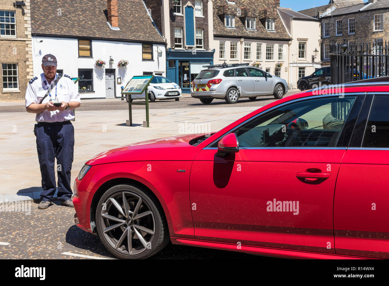 King's Lynn Norfolk un gardien de stationnement ou un garde-trafic donnant un billet pour une voiture garée illégalement St Margaret's place King's Lynn Norfolk Angleterre GB Royaume-Uni Banque D'Images