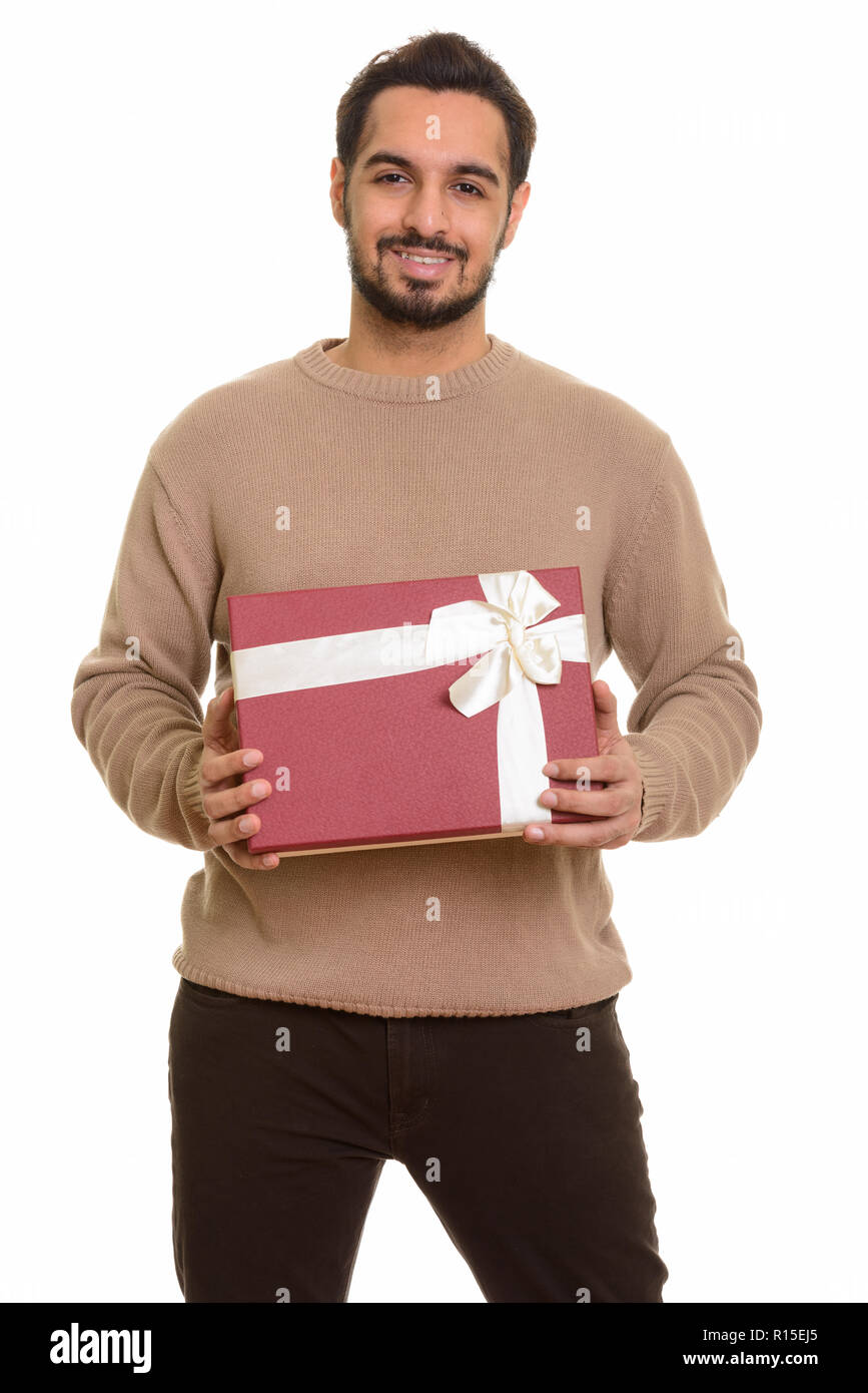 Young happy Indian man holding gift box prêt pour la Saint Valentin da Banque D'Images