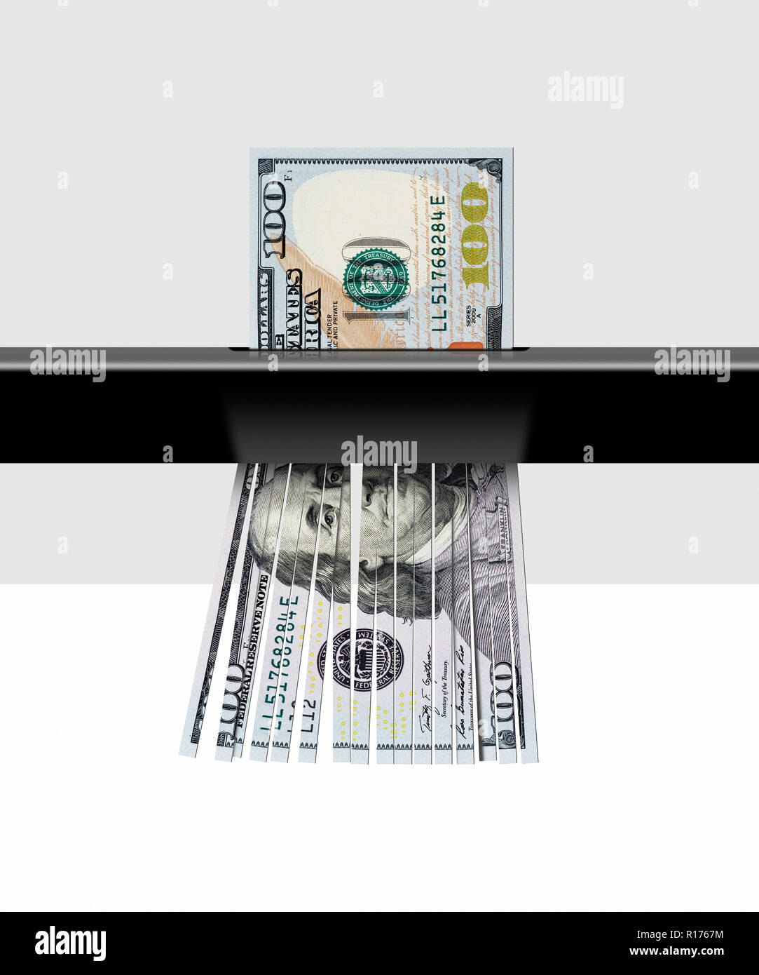 Shredding 100 dollar USA banknote, fond gris Banque D'Images