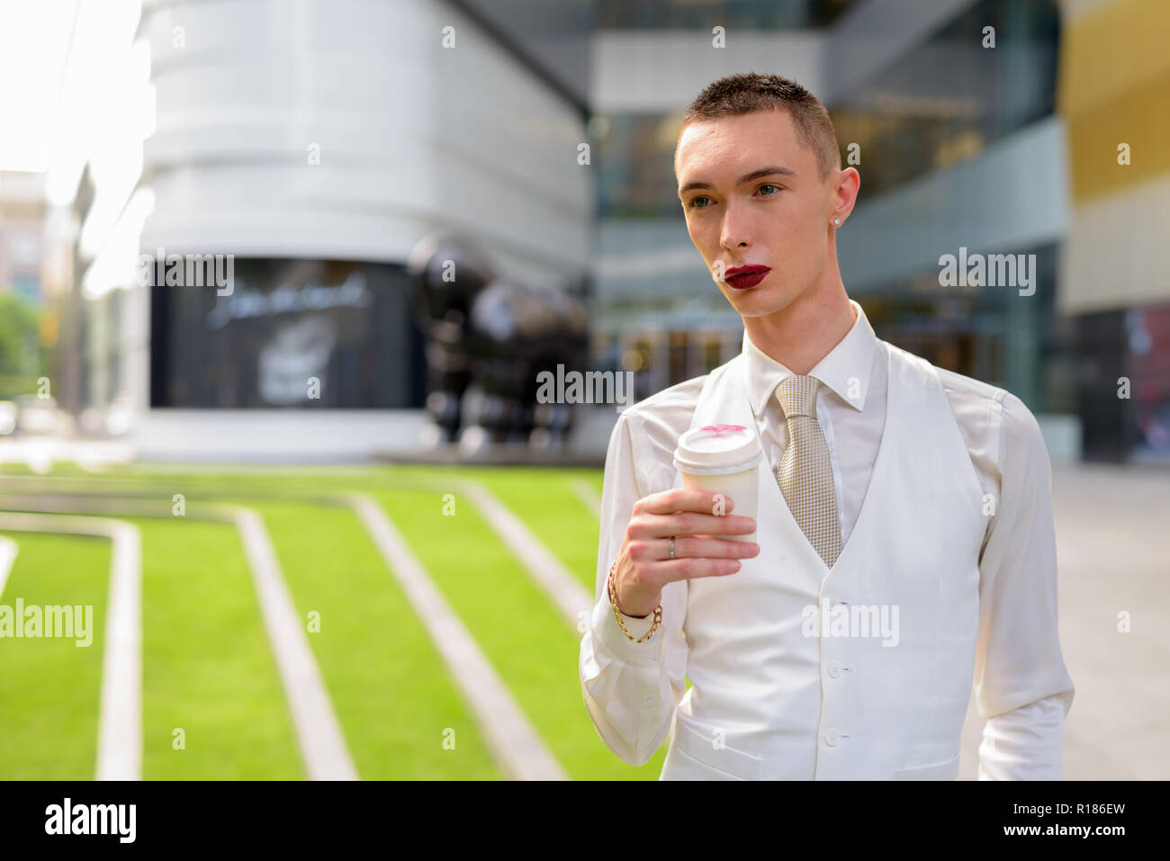 Les jeunes homosexuels androgyne LGTB businessman drinking coffee Banque D'Images