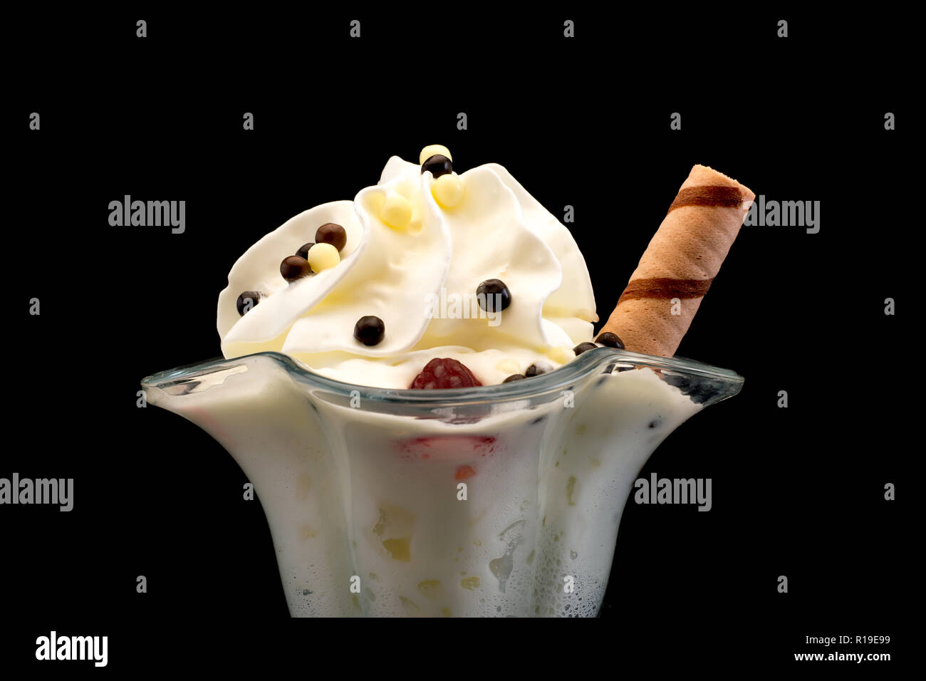 La crème glacée aux framboises et chocolat balls dans un beau gros plan de verre sur fond noir Banque D'Images
