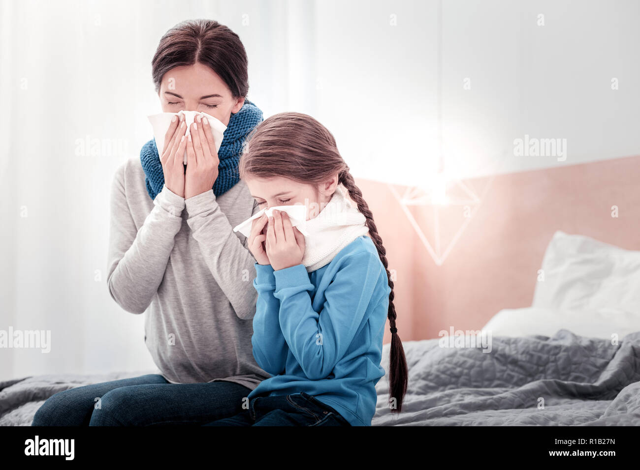 Portrait de Mère et fille soufflant leur nez Banque D'Images