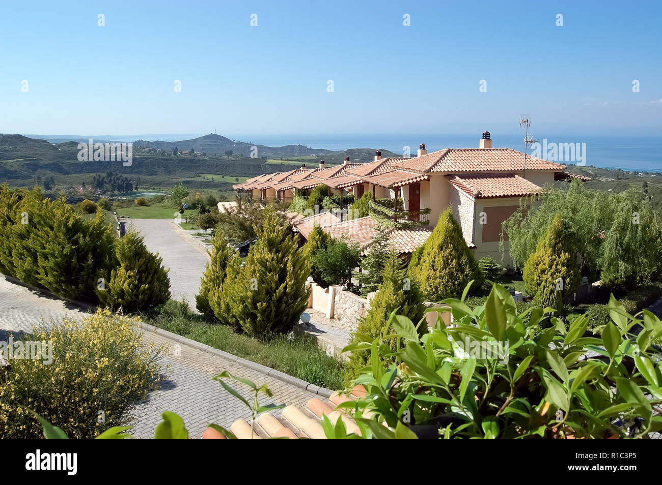 Hanioti, Grèce - 05 mai 2012 : une vue panoramique sur le pittoresque terrain montagneux, le bleu de la mer et les villas du complexe Akritas Ef Zin Villas. Banque D'Images