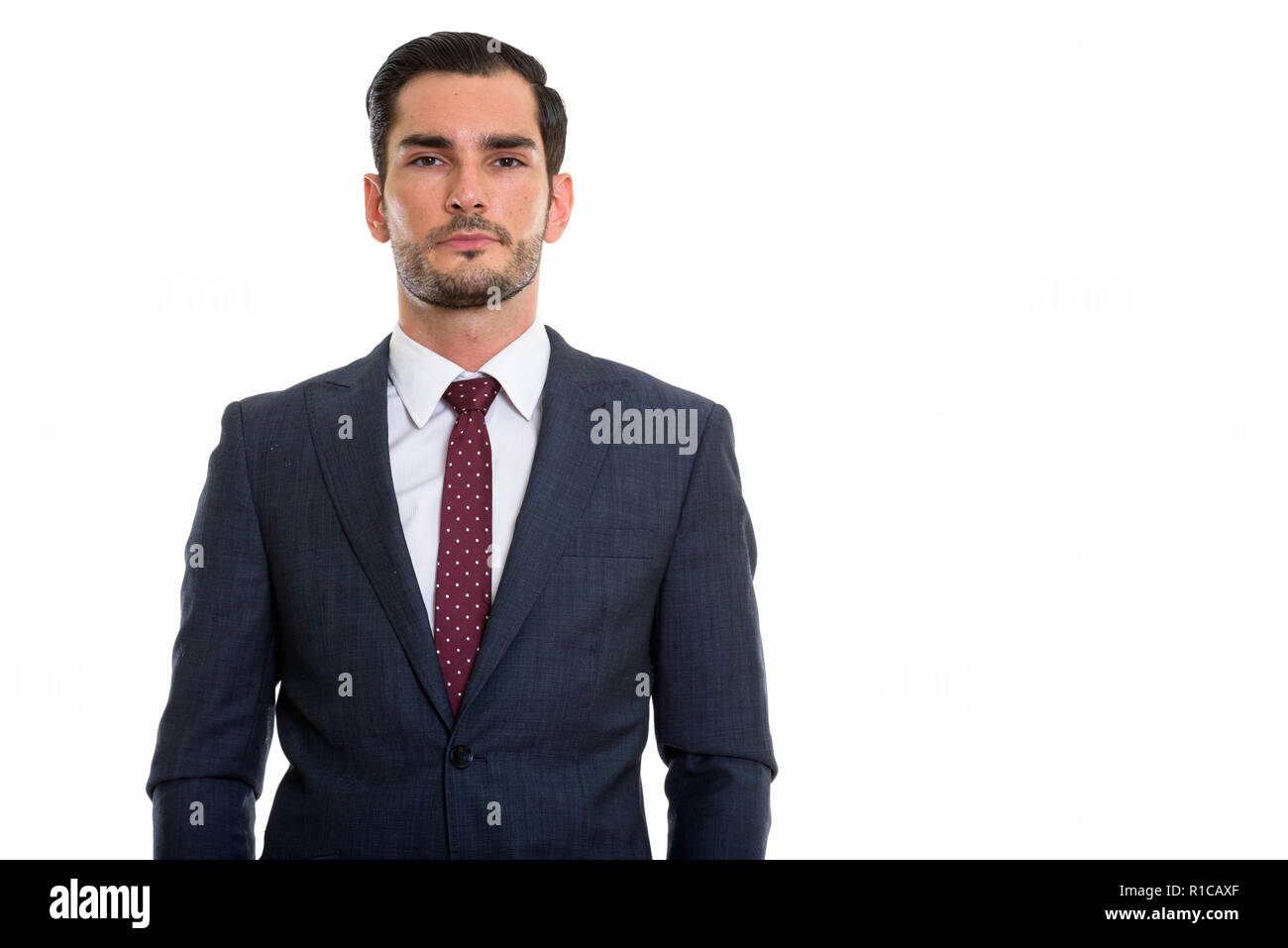 Studio shot of young handsome businessman looking at camera Banque D'Images