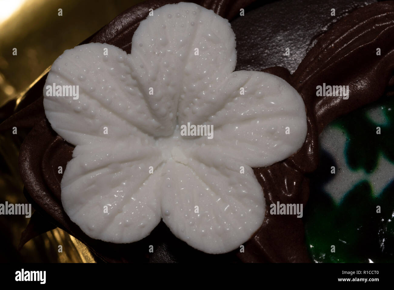 Fondant blanc fleur sur le gâteau au chocolat Banque D'Images