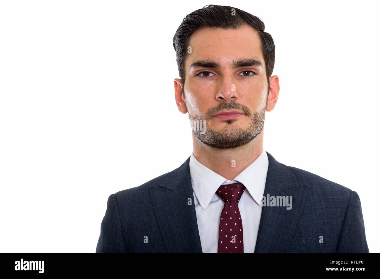 Studio shot of young handsome businessman looking at camera Banque D'Images