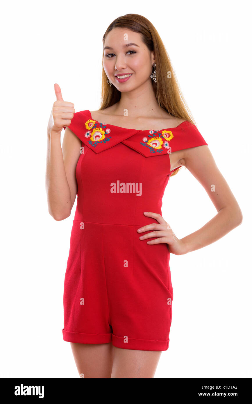 Studio shot of young happy Asian woman smiling et Giv Banque D'Images