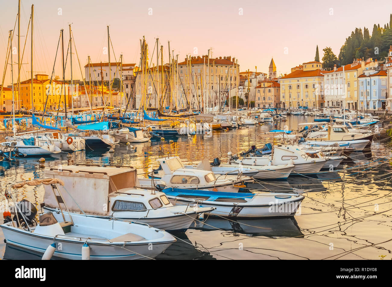 Jetée pour l'amarrage de bateaux de pêche et de yachts sur la côte méditerranéenne, à l'aube. Piran, Slovénie. Banque D'Images