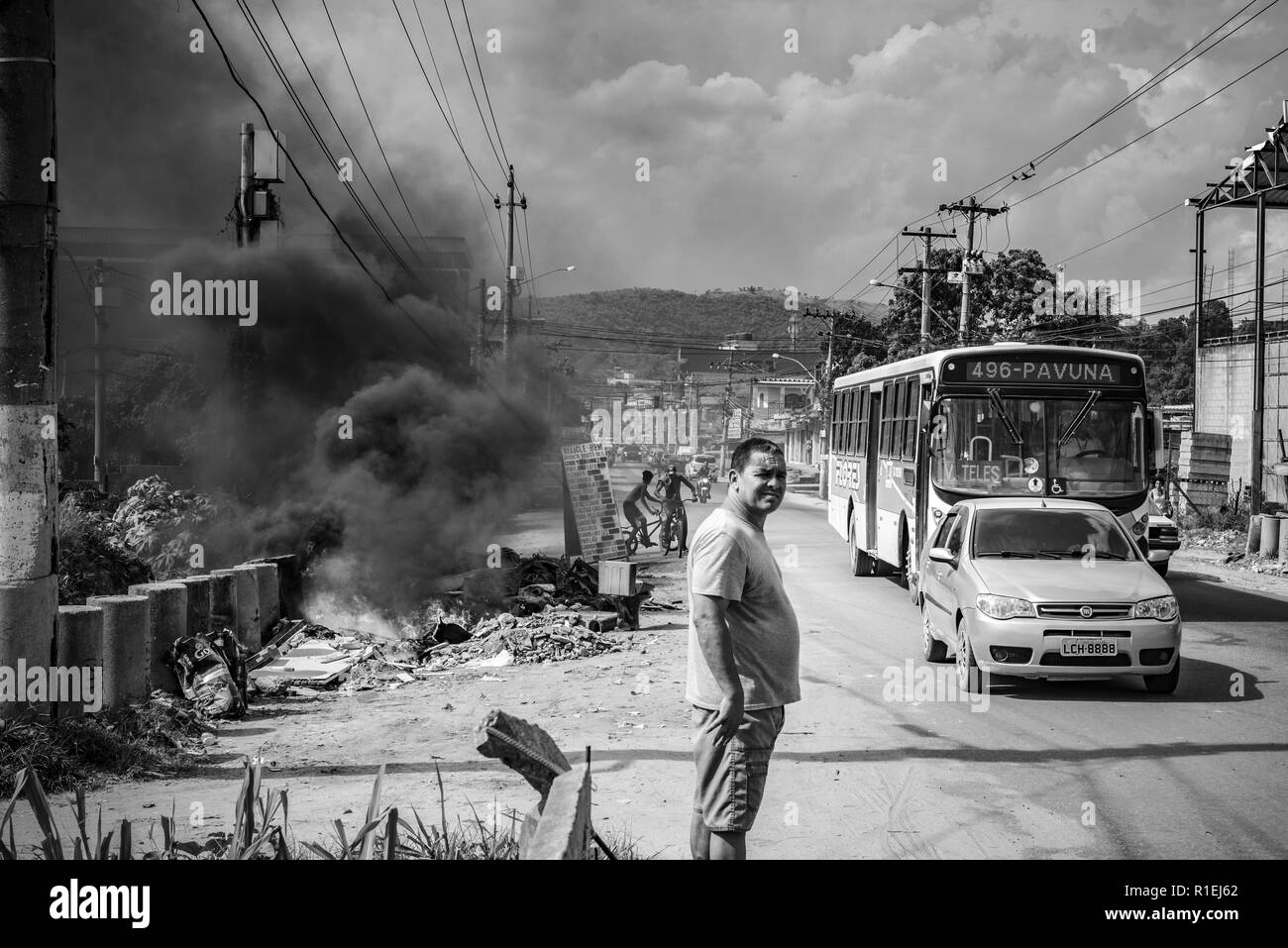 Rue de Rio de Janeiro avec des bidonvilles de bus allant de la route et le feu avec fumée noire à la combustion des déchets à côté de la route Banque D'Images