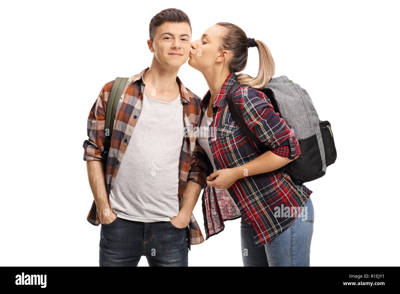 Teenage girl kissing un adolescent isolé sur fond blanc Banque D'Images