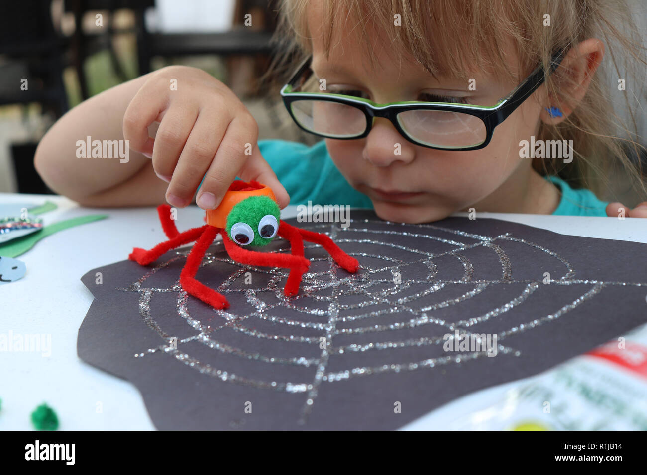 Petite fille jouant avec son spider, colorée malveillante Banque D'Images